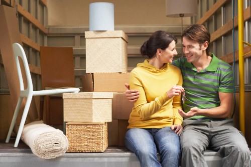 Moving team preparing wooden furniture for storage